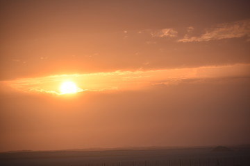 Sunrise in the summer with golden clouds.