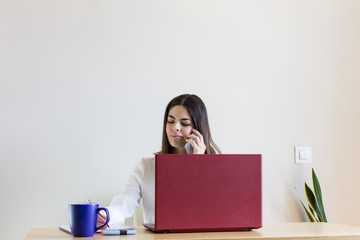 Happy casual pretty woman working from home during confinement season, telecommuting.