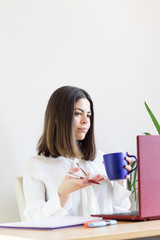 Happy casual woman teleworking from home due to Covid-19 situation. Explaining something to your employees.