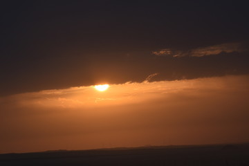 Fototapeta na wymiar Sunrise in the summer with golden clouds.