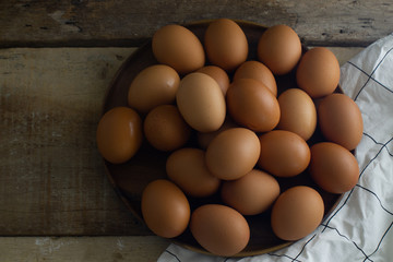 Group Raw Eggs on Wooden Background