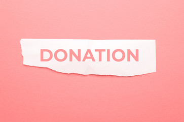 Donation lettering on pink background.