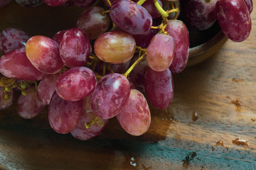 Grape and wooden plate and background