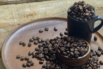 Roasted Coffee beans on grunge wooden can be used as a background