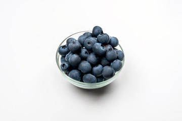 Blueberries in a glass Cup on a white background