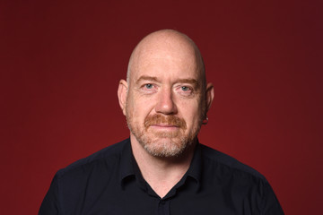 portrait of a bald man on red background