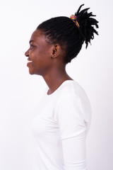 Profile view of happy young beautiful African woman smiling