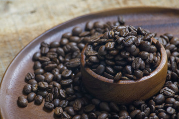 Roasted Coffee beans on grunge wooden can be used as a background