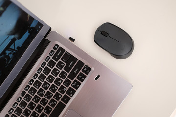 Laptop on a table and black mouse