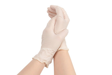 Woman puts on white rubber gloves.