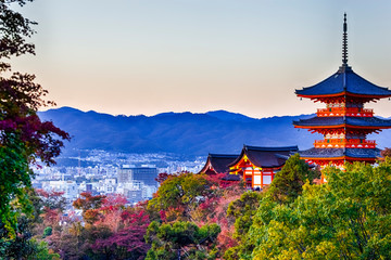 Japanese Heritage. Renowned Kiyomizu-dera Temple Pagoda Against Kyoto Skyline  and Traditional Red Maple Trees in Background in Japan.