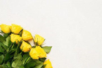 Yellow roses bouquet on light background. Mothers day, Valentines Day, Birthday celebration concept. Copy space, top view