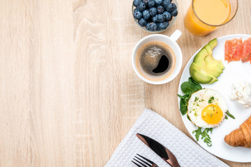 Light European Breakfast with salmon and avocado. Orange juice and coffee as a morning tradition..