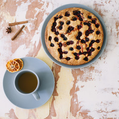 Piece of pie on plate with cup of tea on white table. Breakfast with tea and cake. Food photography. Table top photo. Tea time