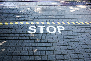 Fototapeta na wymiar Stop written on floor asphalt concept image