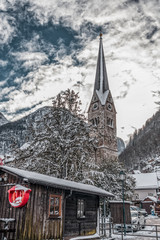 Evangelical parish church covered in snow in Hallstatt village in Austria in winter