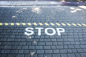 Fototapeta na wymiar Stop written on floor asphalt concept image