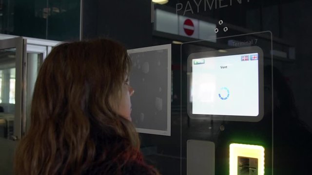 Close up shot of woman that is finishing payment on a service screen.