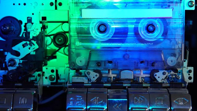Old retro cassette tape recorder. Colored disco lights illuminate the cassette. Retro tape recorder.