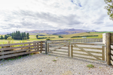 Fototapeta premium Closed wooden farm gate at the entrance to a farm