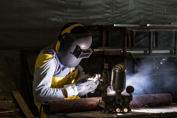 Worker welding the steel part by manual