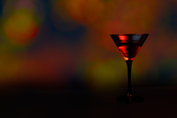 Glass of red vermouth, black table and boket background