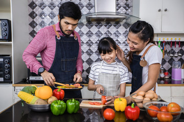 Asian families are cooking  and parents are teaching their daughters to cook in the kitchen at home. .Family activities on holidays and Happy in recreation concept