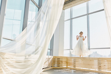 Fashion bride in gorgeous wedding dress. Beautiful model with bridal makeup and hairstyle in marriage dress.