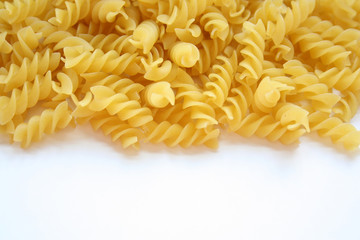 Twisted pasta lie on a white background. Close-up.