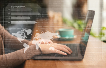 Female hacker using laptop looking at database server