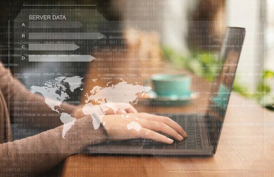 Female hacker using laptop looking at database server