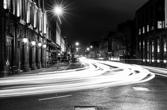 Fototapeta Stunning black and white night shot with light streams in European city - Dublin