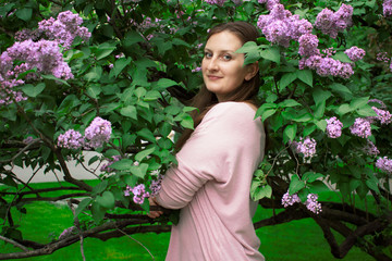 portrait of a young girl in a flowering lilac