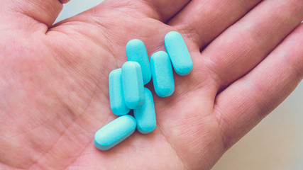 Vitamins, medicine on the palm of your hand. Different positions and colors.