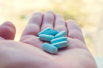Vitamins, medicine on the palm of your hand. Different positions and colors.