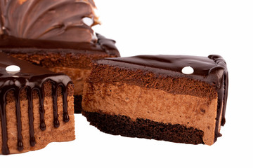 Piece of chocolate cake with chocolate glaze on white background