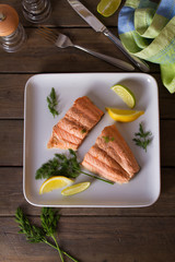 Poached salmon fillets. Boiled salmon on white plate. Healthy diet fish dish. View from above, top studio shot