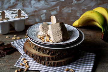 Homemade ice cream pops with peanut butter and banana flavor. Summer refreshment, healthy dessert. Close up