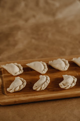 Fototapeta na wymiar dumplings on a wooden cutting board