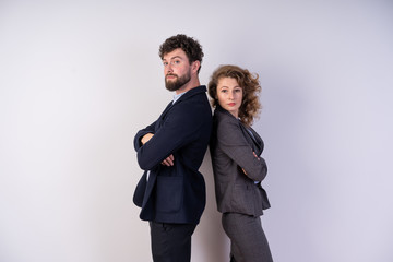 Business man and woman stand side by side. put she her hands and confidently look forward to the professionals