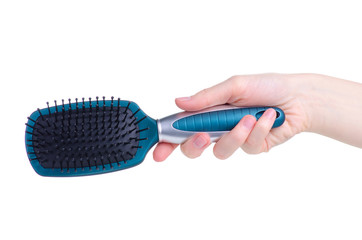 Blue hair brush in hand on white background isolation