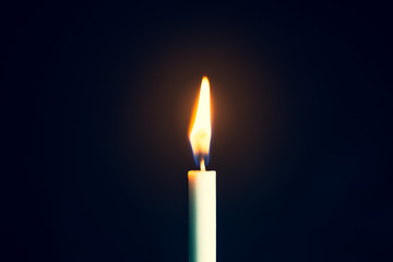 Single lit candle with quite flame, Photos Candle light flame against black background. Concept of memory, remembrance, mourning, grief, and sorrow 