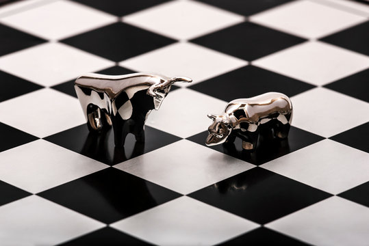 Silver Bull And Bear On A Chessboard