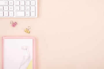 Creative flat lay photo of desktop. Top view office desk with keyboard, pencil, notebook on a beige color background. Top view with copy space, flat lay of photography.