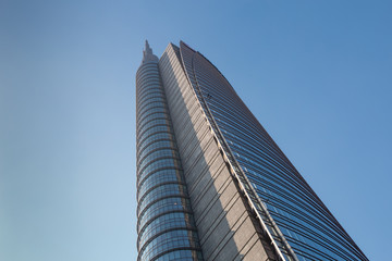 Fototapeta premium A huge multi-story modern office building against a blue sky. 01.2020 Milan