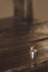 wedding rings on a wooden table
