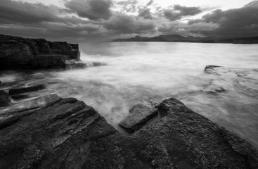  Black and white seascape with curly sky and thunderclouds