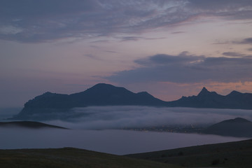 Fototapeta na wymiar Gloomy mountain landscape with fog