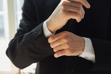 Fototapeta premium Wearing black jacket. Close up of caucasian male hands, working in office. Concept of business, finance, job, online shopping or sales. Copyspace for advertising. Education, communication freelance.