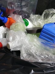 Plastic waste in a black garbage bag.
